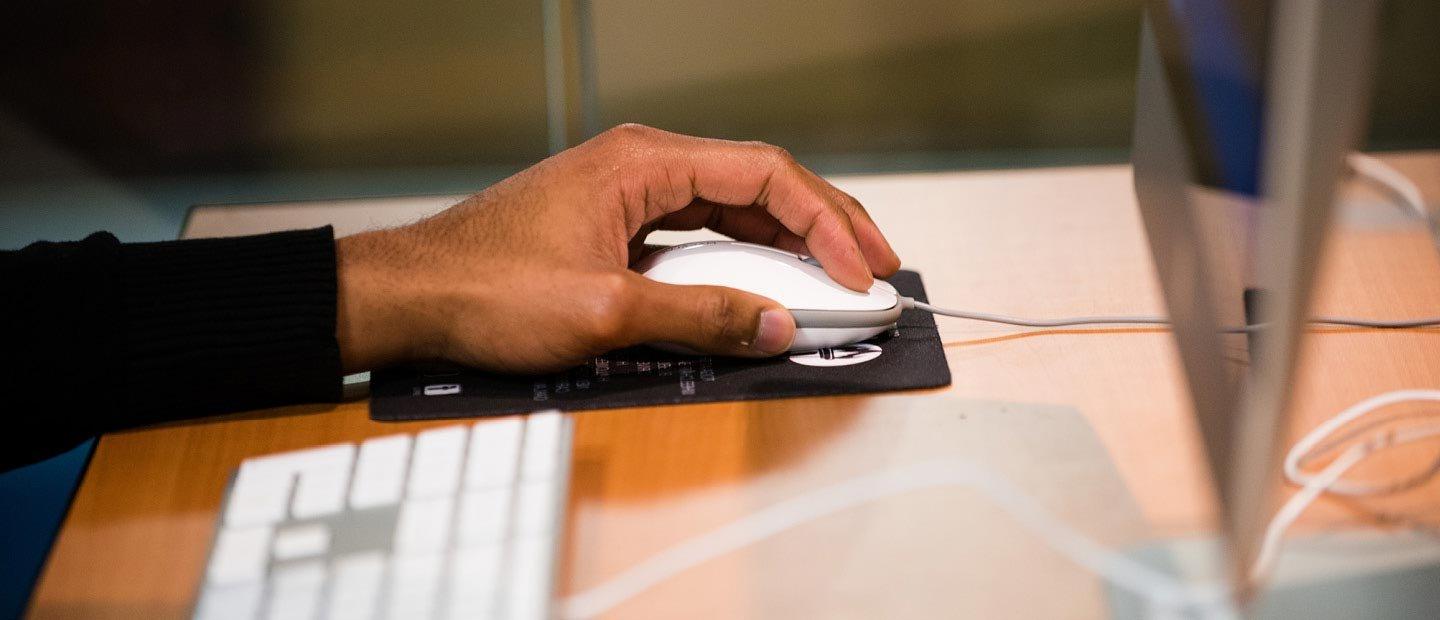 Closeup of a hand using a computer mouse